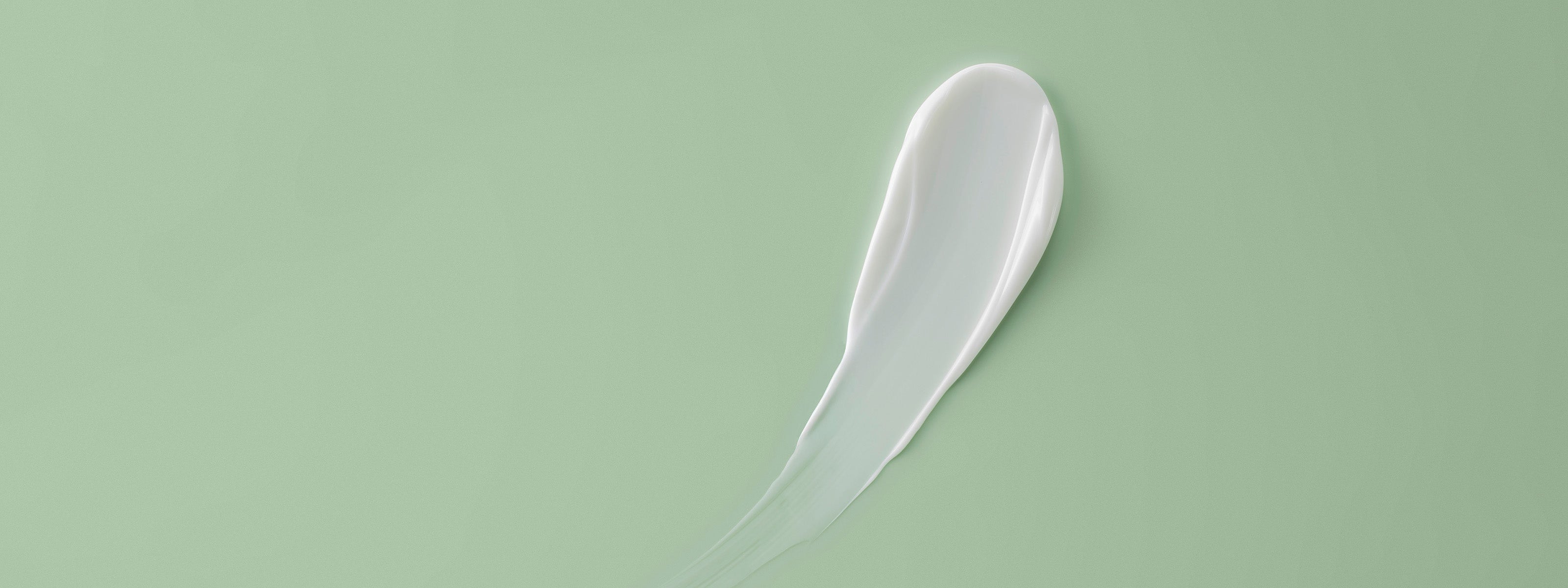 Texture de crème sur fond vert